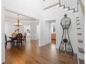 Grand foyer with hardwood floors and staircase, leading to dining area at 1102 White Cloud Rdg, Snellville, GA 30078