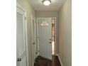 Hallway with a door with a semi-circular window leading to the outside, bringing in natural light at 2630 Colonial Dr, College Park, GA 30337