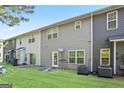 Spacious backyard featuring green grass, gray siding, and multiple windows at 3032 Cedar Glade Ln, Buford, GA 30519
