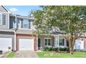 Charming townhome boasts a blend of brick and siding, complemented by a well-manicured lawn at 3032 Cedar Glade Ln, Buford, GA 30519