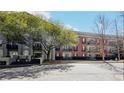 Multi-unit building with a mix of brick and light-colored exteriors, accented by mature trees at 3071 Lenox Ne Rd # 11, Atlanta, GA 30324