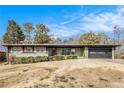 Charming single-story home with a well-manicured lawn and blue sky at 635 Reed Se Rd, Smyrna, GA 30082