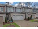 Street view of attractive townhomes, featuring neutral siding and two car garages in a modern design at 2136 Garden Pl, Atlanta, GA 30316