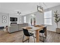 Bright, open-concept living room with a dining area, modern lighting and hardwood floors at 2136 Garden Pl, Atlanta, GA 30316