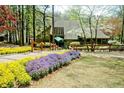 Community clubhouse featuring a well-manicured landscape with lush gardens and a grand entrance at 4941 Isle Royal Ct, Stone Mountain, GA 30088