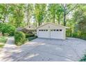 View of the two-car garage and extra wide driveway, ideal for extra parking at 130 Bonnie Ln, Sandy Springs, GA 30328