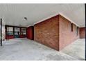 Attached carport featuring a concrete floor and brick wall at 2516 Warwick Ne Cir, Atlanta, GA 30345