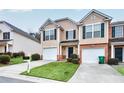 Charming townhome with a well-manicured lawn and single-car garage and inviting curb appeal at 3682 Harvest Dr, Decatur, GA 30034