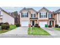 Inviting townhome features a well-manicured lawn, a one-car garage, and a charming front entrance at 3682 Harvest Dr, Decatur, GA 30034