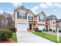 Well-maintained two-story townhome with a single-car garage and tidy front yard landscaping at 3682 Harvest Dr, Decatur, GA 30034