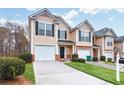 Inviting townhome features a well-manicured lawn, a one-car garage, and a charming front entrance at 3682 Harvest Dr, Decatur, GA 30034