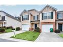 Inviting townhome features a well-manicured lawn, a one-car garage, and a charming front entrance at 3682 Harvest Dr, Decatur, GA 30034