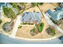 Overhead view of a brick house with driveway and manicured lawn in a residential area at 720 First Cotton Dr, Powder Springs, GA 30127