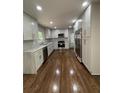 Modern kitchen with white cabinets, stainless steel appliances, and hardwood floors at 1759 Wilmont Ne Dr, Atlanta, GA 30329