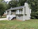 A two-story home featuring a chimney and well-maintained lawn at 2961 Forelock Sw Pl, Marietta, GA 30064