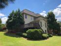 Backyard view of a home with a deck, lush green lawn, and mature trees at 2741 Willowstone Dr, Duluth, GA 30096