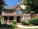 Brick home with stone accents, covered front porch and manicured landscaping at 2741 Willowstone Dr, Duluth, GA 30096