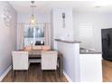 Cozy dining area featuring modern lighting fixture, neutral walls, and a sliding glass door at 2763 Snapfinger Mnr, Decatur, GA 30035