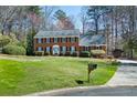Classic two-story brick residence with green lawn, driveway, and well-maintained landscaping and mailbox at 1121 Valley Ridge Se Ct, Marietta, GA 30067