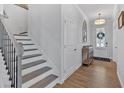 Bright entryway with hardwood floors, staircase, and decorative accents at 12 Ridgeline Nw Way, Cartersville, GA 30121
