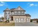 Charming two-story home with a brick and gray exterior, complemented by a spacious three-car garage at 12 Ridgeline Nw Way, Cartersville, GA 30121