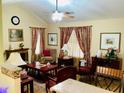 A well-decorated living room showcasing ample seating, a decorative fireplace, and a ceiling fan at 140 Thrasher Rd, Covington, GA 30016