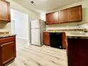 Bright kitchen with stainless steel fridge and black dishwasher, complemented by wood-look flooring at 2526 Piering Dr, Lithonia, GA 30038