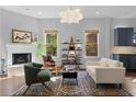 Cozy living room with fireplace, hardwood floors, decorative rug, and ample natural light at 267 Connecticut Ne Ave, Atlanta, GA 30307
