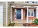 Welcoming front porch with brick accents, white columns, and a classic black front door with sidelights at 3925 Keystone Nw Rdg, Acworth, GA 30101