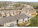 Aerial view of townhomes with manicured landscaping, attached garages, and proximity to roads and wooded areas at 2286 Emerald Sky Dr, Smyrna, GA 30080