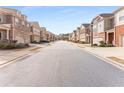 Street view of a townhome community showing rows of townhomes with attached garages and tidy landscaping at 2286 Emerald Sky Dr, Smyrna, GA 30080