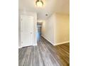 Inviting entryway featuring modern gray plank flooring, neutral paint, and a view down the hall at 2533 Piering Dr, Lithonia, GA 30038