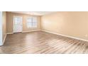 Bright living room features new flooring, large window, and neutral paint at 256 Olde Oaks Ln, Riverdale, GA 30274