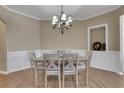 Dining room with hardwood floors, wainscoting and chandelier at 300 Knelston Oak Dr, Suwanee, GA 30024