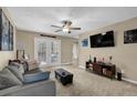 Comfortable living room with a ceiling fan, ample seating, and views through the French doors at 3608 Stedman Pl, Duluth, GA 30096