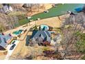 Aerial view of a beautiful home with a large yard, waterfront, and a private in-ground pool at 770 Huiet Dr, Mcdonough, GA 30252