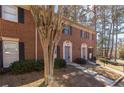 Brick townhome with well-maintained landscaping and walkway at 2828 Webb Bridge Rd, Alpharetta, GA 30009