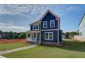 Attractive two-story home featuring a well-maintained lawn and a front porch at 4040 Andover Cir, Mcdonough, GA 30252