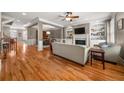 Open-concept living room featuring hardwood floors and a cozy fireplace at 5002 Davenport Pl, Roswell, GA 30075