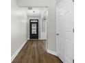 Inviting foyer with dark wood-look floors and a view of the glass-paneled front door at 3119 Devauden Ct, Duluth, GA 30096