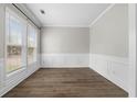 Bright room with wainscoting and large windows offering ample natural light, wood-look flooring at 3119 Devauden Ct, Duluth, GA 30096