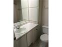 White bathroom with a single sink vanity, built-in storage, and a black and white tile floor at 524 Northridge Crossing Dr, Atlanta, GA 30350
