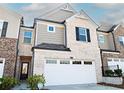 Attractive townhouse showcasing a blend of brick and gray siding accents at 1277 Sunny Lake Dr, Lawrenceville, GA 30043