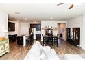Open floor plan with hardwood floors seamlessly connecting the kitchen and living areas at 1277 Sunny Lake Dr, Lawrenceville, GA 30043
