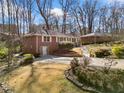 Brick home with well-maintained lawn, landscaped with greenery, hardscape and flowering bushes at 750 Parkway Se Dr, Smyrna, GA 30080
