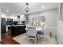 Bright dining area with a modern table set and a view into the updated kitchen with stainless steel appliances at 64 Montre Nw Sq, Atlanta, GA 30327