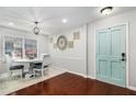Charming dining area with a round table, stylish chairs, natural light, and a decorative teal door at 64 Montre Nw Sq, Atlanta, GA 30327