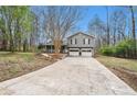 Inviting two-story home featuring a two-car garage and a long concrete driveway at 79 Mountain View Ct, Dallas, GA 30157