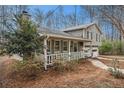 Charming home with a welcoming covered porch and lush landscaping at 79 Mountain View Ct, Dallas, GA 30157