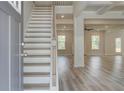 Bright entryway featuring hardwood floors, staircase, and an open view to the spacious living area at 200 Haverling Pass, Hampton, GA 30228